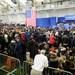 Some audience members rest their feet as they sit on the ground as they wait for the President of the United States Barack Obama to speak at the Al Glick Fieldhouse on Friday morning. Melanie Maxwell I AnnArborcom